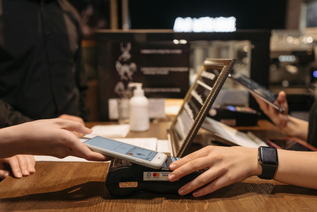 Tapping a phone on a payment terminal — mobile money moment